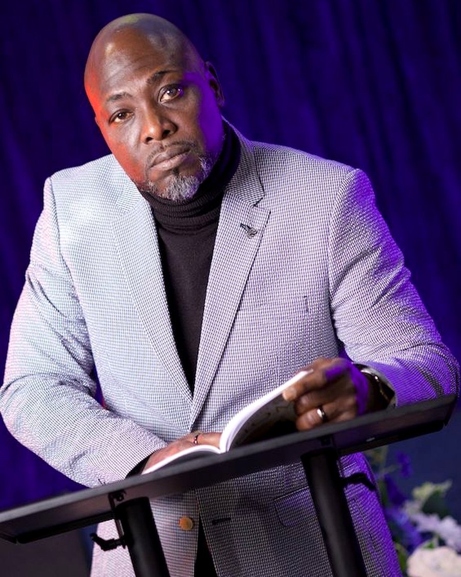 Kunle reading The Long Way Home in a quiet moment